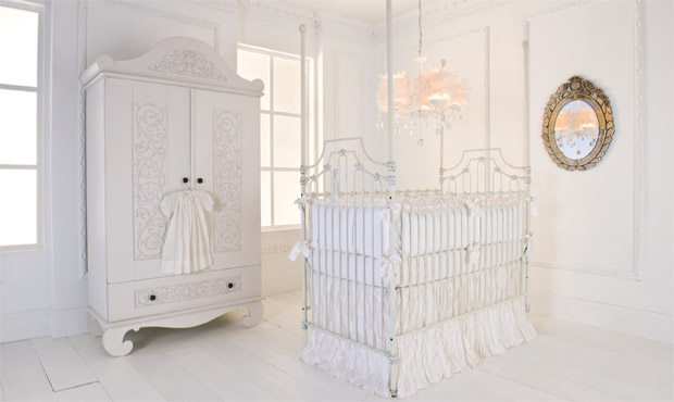 Exclusive elements such as crushed silk, distressed cast iron, carved wood, and crystal make this all white nursery a designer's delight.