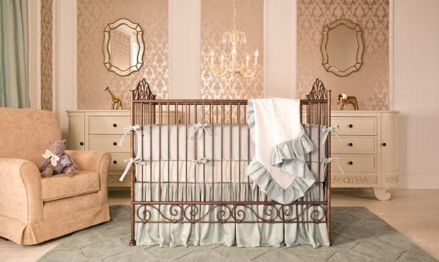 The nursery is defined by its subtle and relaxed elegance and is perfect for a boy or girl. We love the cool tones in the bedding, rug, and window treatments singing against the warm metallic golds.  