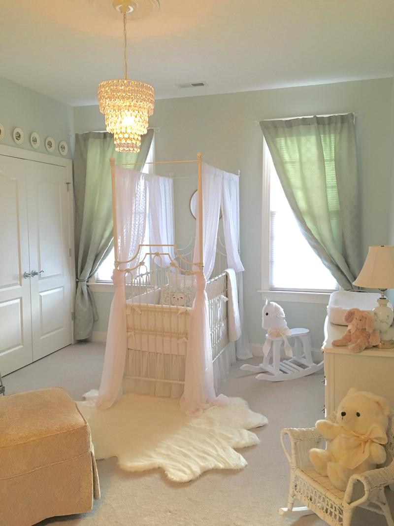 White parisian crib in baby girl nursery